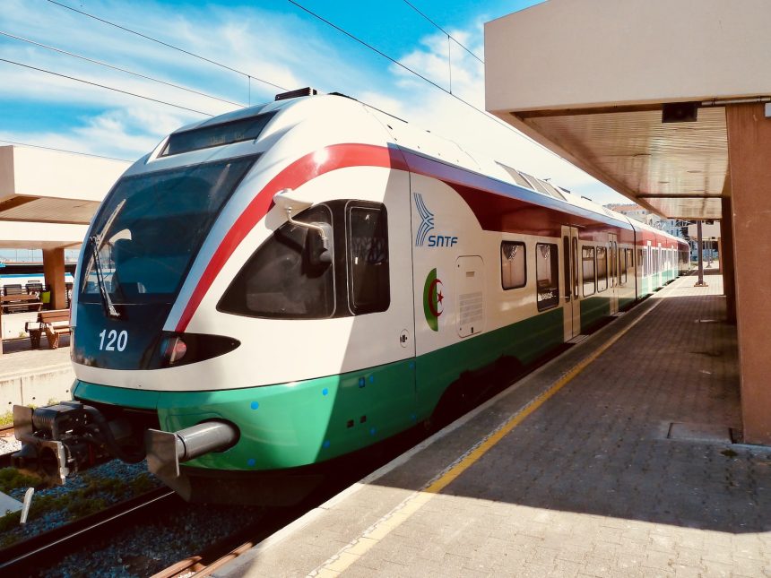 white and blue train on rail during daytime